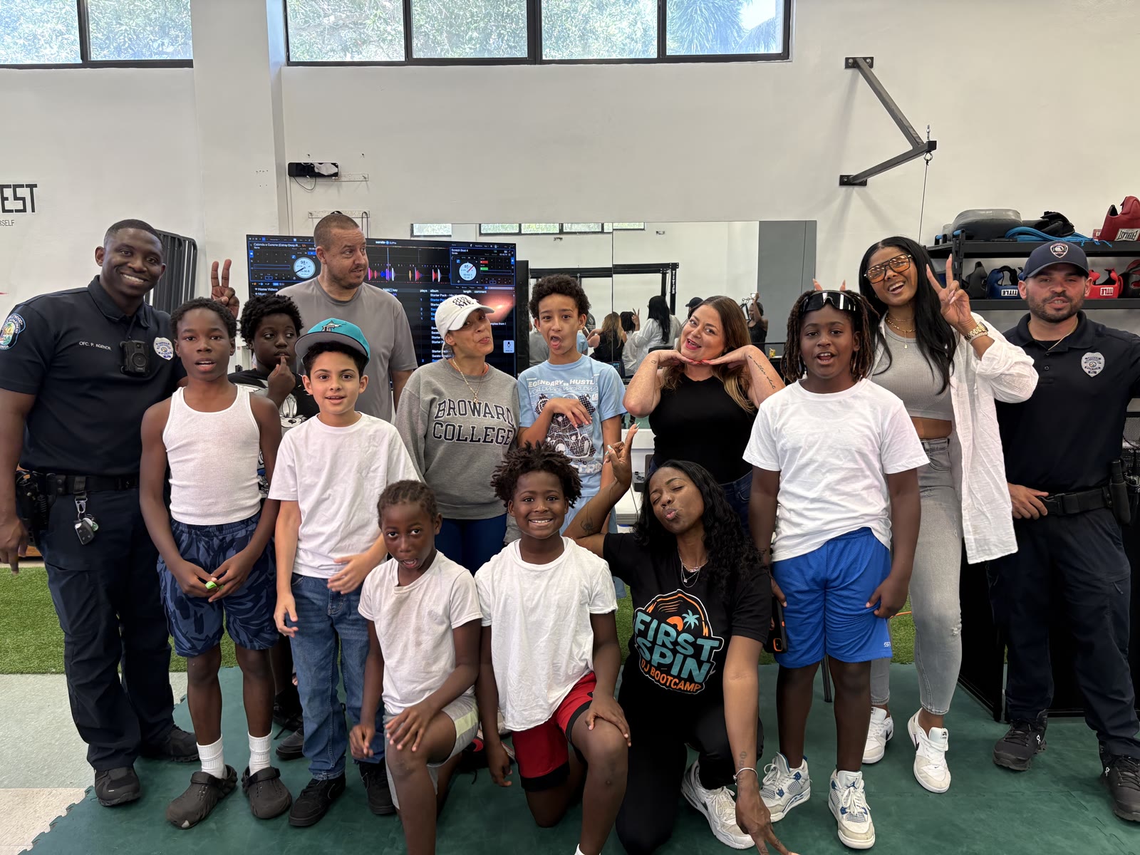 DJ ReRe and the First Spin students with Hollywood Police officers at the Hollywood PAL gym.