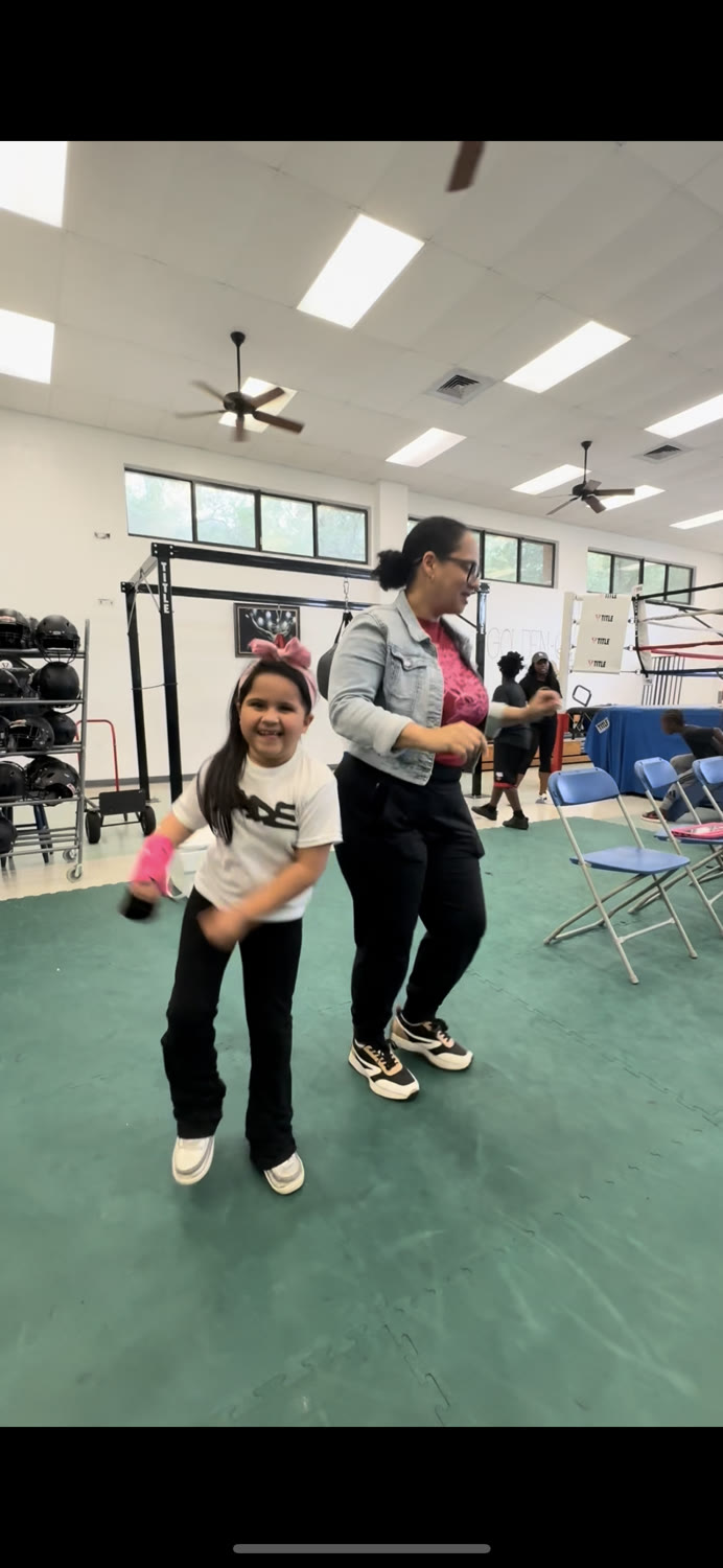A First Spin parent dancing with their child at the showcase.